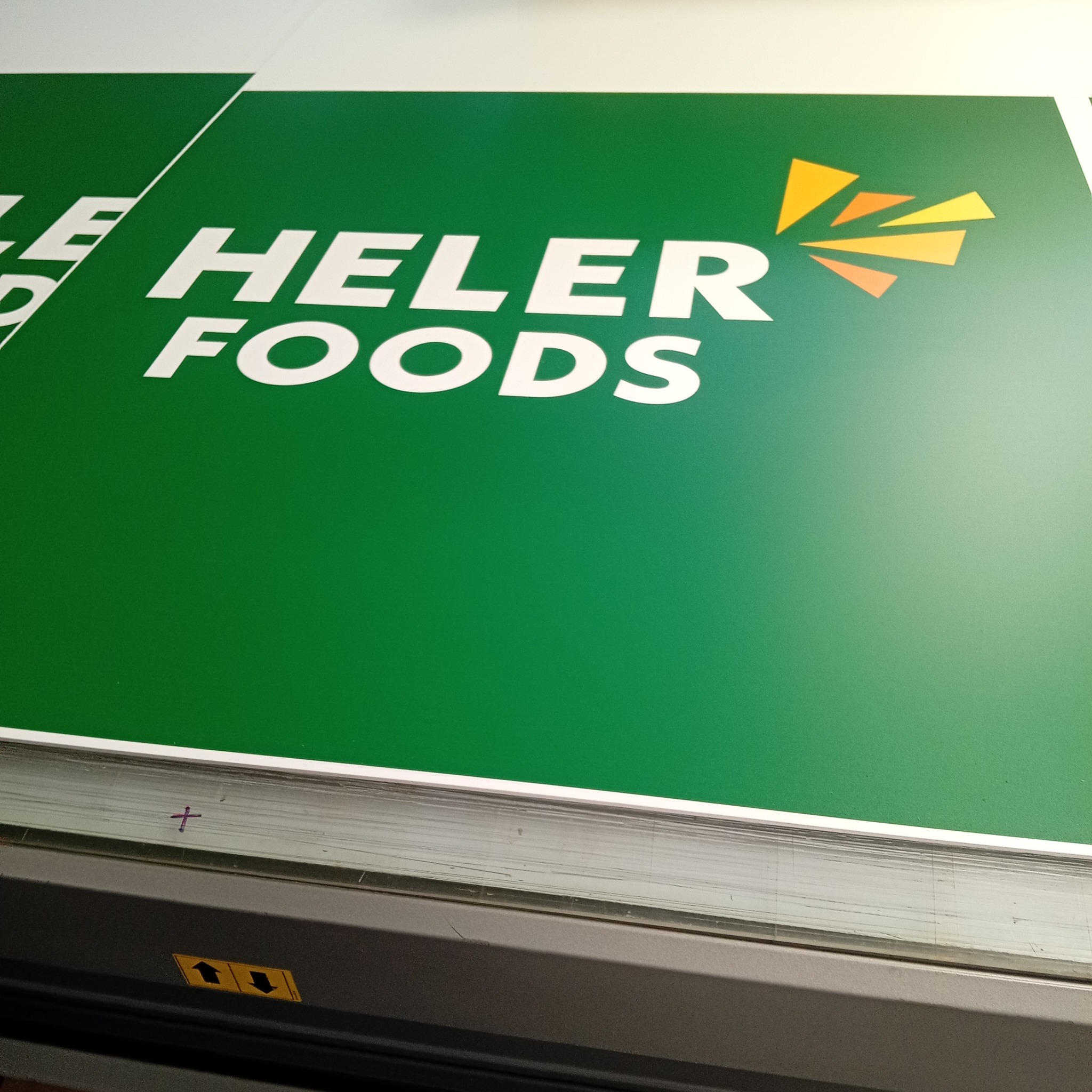 Heler Foods branded green panel printed by Backdrop Media